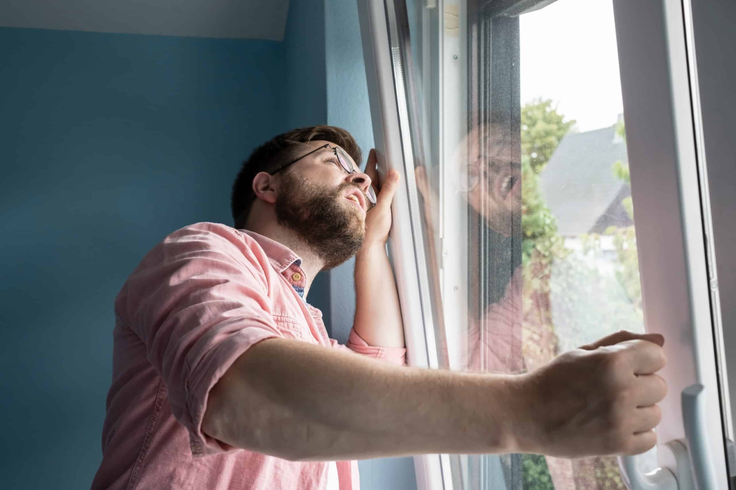 A man looking out of a window.